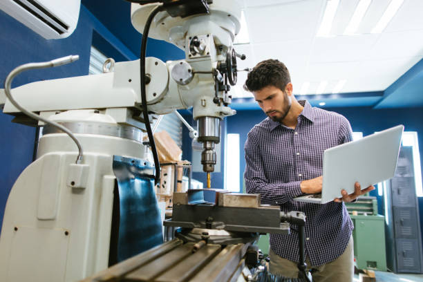 young latin engineer calibrating drill - mechanic tools imagens e fotografias de stock