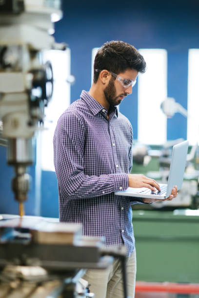 istock Millennial engineer concentrated on laptop in shop 1057719128