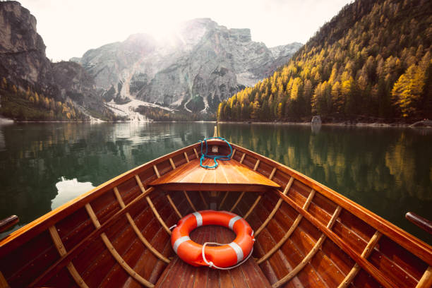 istock Traditional rowing boat on a lake in the Alps in fall 1057725796