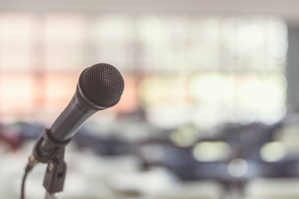 istock Microphone voice speaker in seminar classroom, lecture hall or conference meeting in educational business event for host, teacher, or coaching mentor 1057734342