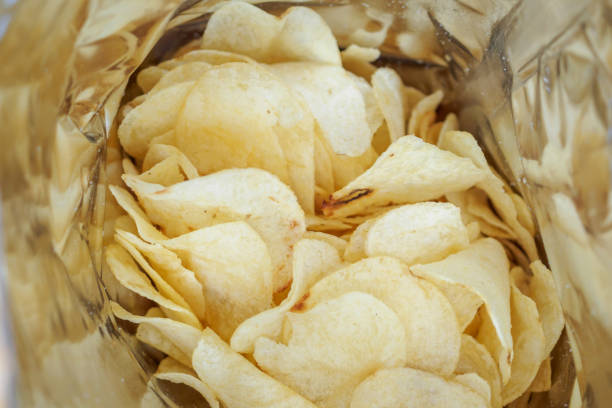 istock Potato chips in open snack bag close up 1057734368