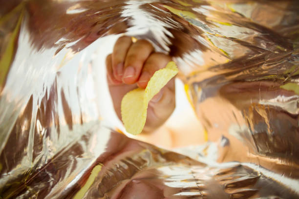 istock Hand hold potato chips inside snack foil bag 1057734370