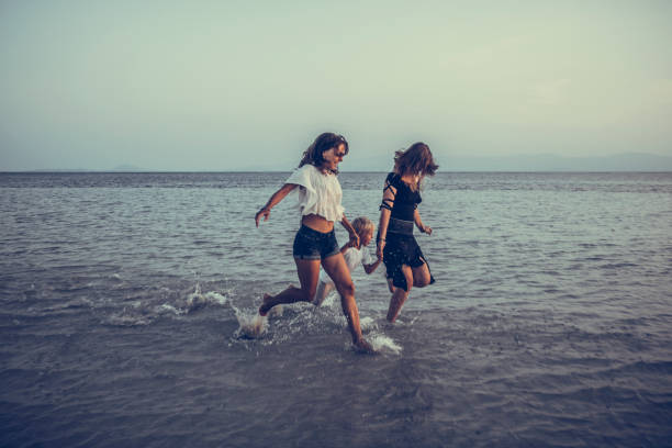 family is running on the tropical beach