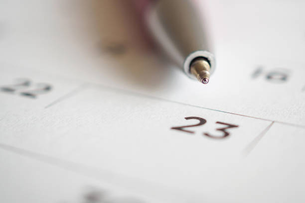 istock Calendar page with pen point at 23rd date 1057734414