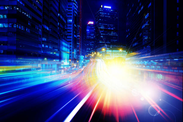 istock City night view with moving traffic light trails. double exposure 1057735246