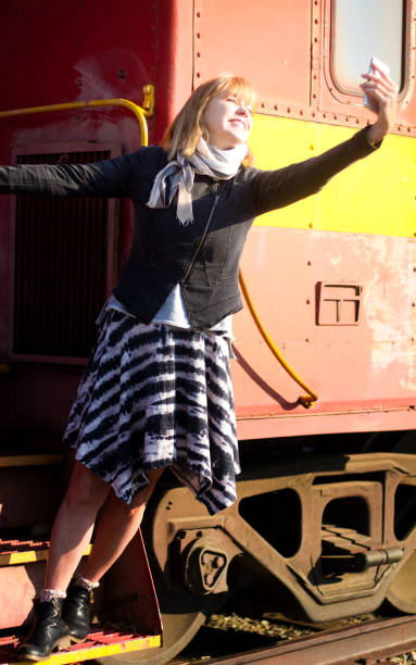 istock Senior Woman Taking Selfie on Vintage Caboose 1057735628