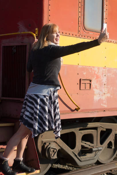 Senior Woman Taking Selfie on Vintage Caboose
