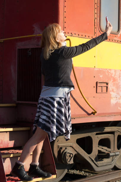 istock Senior Woman Taking Selfie on Vintage Caboose 1057735792