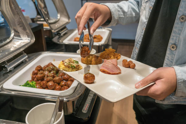 istock People choosing food at a banquet 1057744504