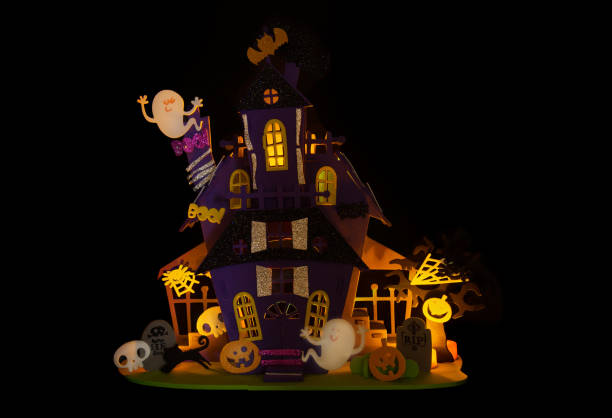 istock Lit up spooky house Halloween decoration with black background 1057748298