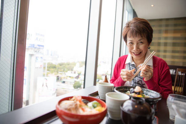 istock Senior woman enjoying having lunch 1057749594