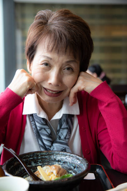 istock Senior woman enjoying having lunch 1057749652
