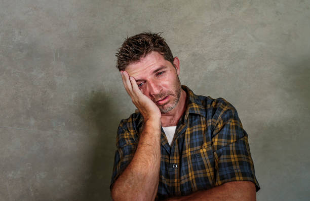 istock dramatic portrait of young sad and depressed man feeling anxious and overwhelmed crying desperate suffering depression problem and anxiety crisis isolated on grey background 1057760258