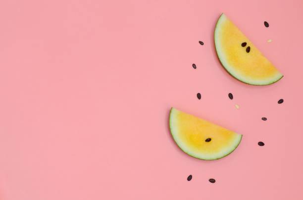 istock Slice yellow watermelon with seeds isolated on pink background with space for text. 1057768290