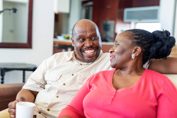istock Happy Senior African Couple Sitting Together on a Sofa 1057770590