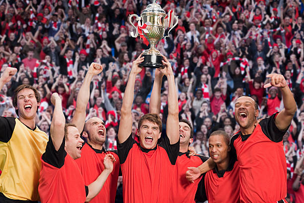 football team winning a trophy - athlete soccer player men professional sport стоковые фото и изображения