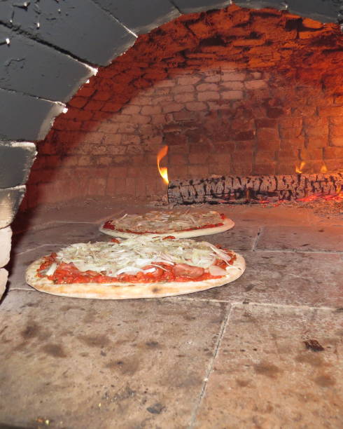 istock baking pizza in the wood oven 1057778326