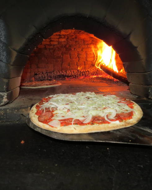 istock baking pizza in the wood oven 1057778386