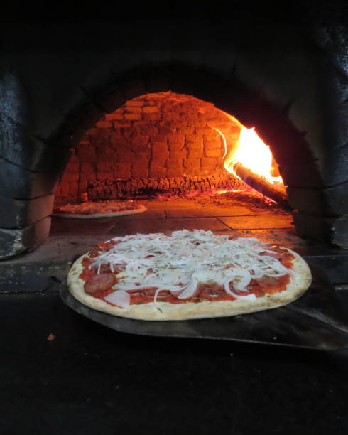 istock baking pizza in the wood oven 1057778418