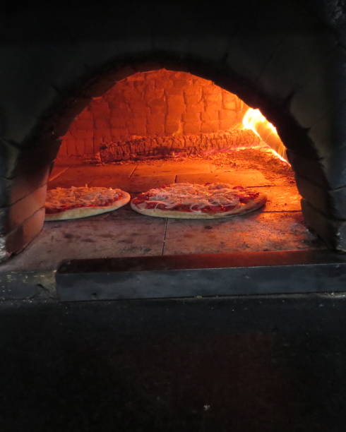 istock baking pizza in the wood oven 1057778434