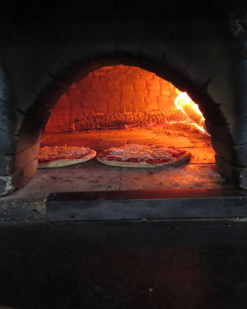 istock baking pizza in the wood oven 1057778440