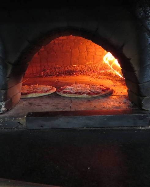 istock baking pizza in the wood oven 1057778482