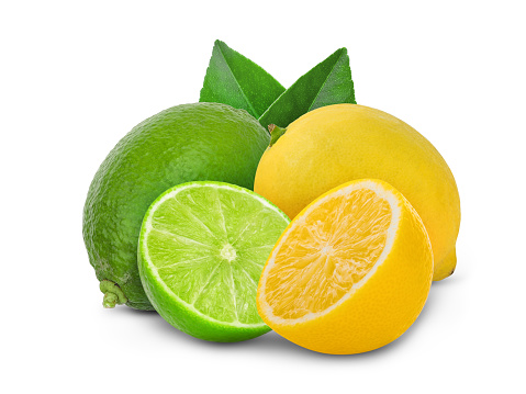 Fresh, ripe yellow lemons and green whole limes with water drops placed on a outdoors fruit market, close up. Vibrant colors. Photography, top view. Organic food background with copy space.