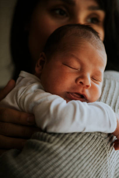 istock Mother holding her baby indoors 1057783002