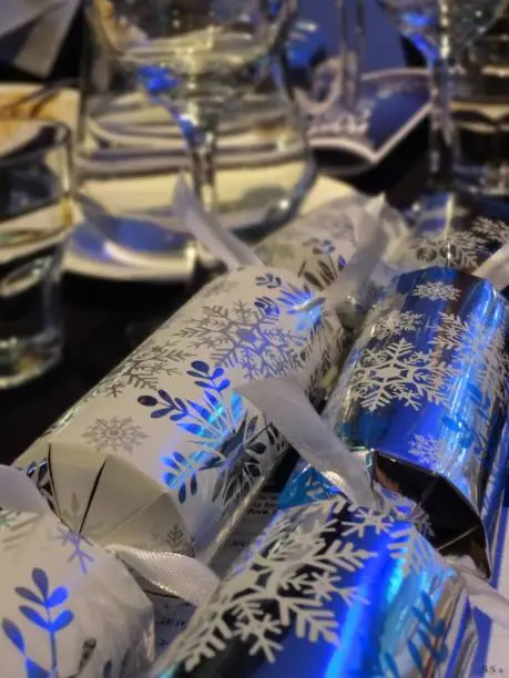 Christmas dinner-table setting with Christmas crackers