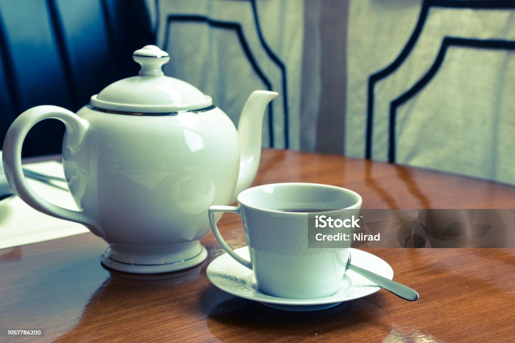 Dining table with tea and teapot Dining table with tea and teapot - vintage Cafe Stock Photo