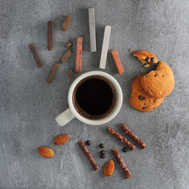 istock cup of coffee on a table with chocolates and pastel crayons 1057790254