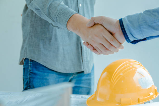istock Asian engineer handshaking for teamwork in Interiors design and construction plan. Architect concept 1057800278