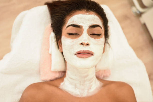 istock Young woman with moisturizer cream mask on her face 1057802682