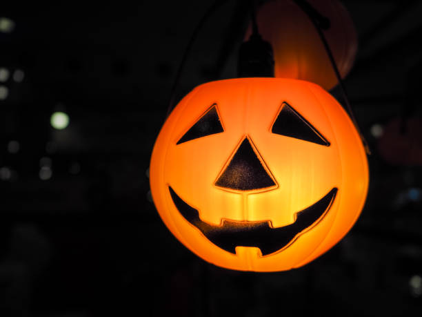 istock Halloween pumpkin head jack lantern with lighting over black background. 1057815076
