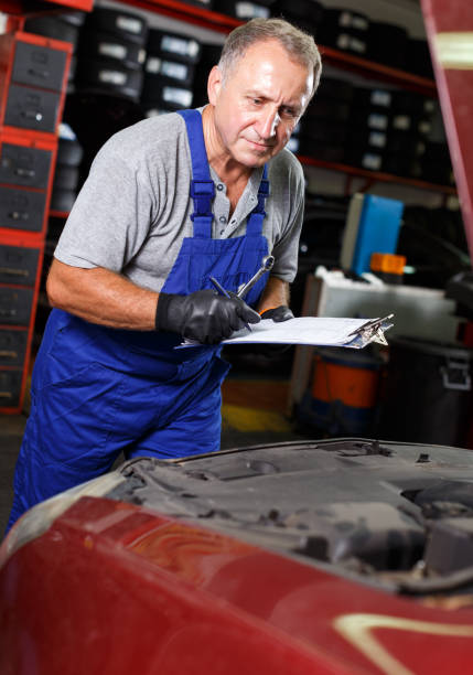 istock Male mechanic taking notes about car repair 1057815096