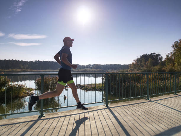 istock Running athlete man, side full body view. Male runner 1057816138