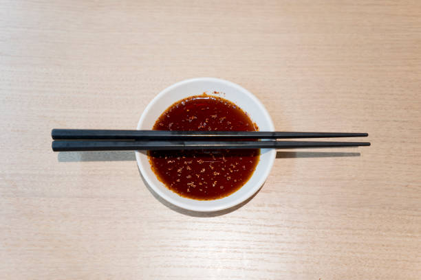 istock Sauce and chopsticks on wooden table 1057818156