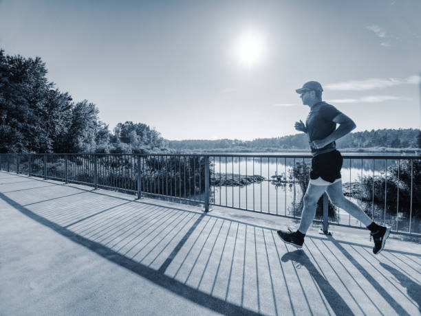 istock Running athlete man, side full body view. Male runner 1057818372