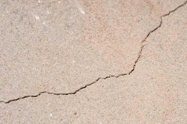 istock Plaster floor with cracks. Building requiring repair closeup. 1057818528