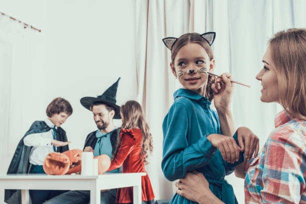 istock Mother helping Daughter with Costume for Halloween 1057819498