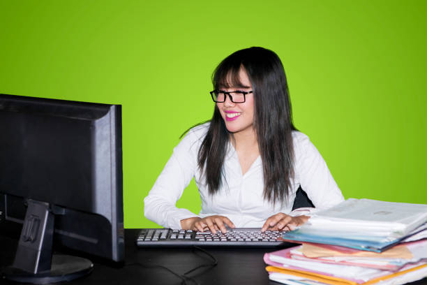 Attractive young business woman works at her desk in the office