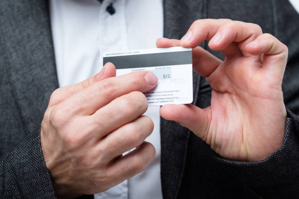 credit card CVC2 code online banking safety credit card CVC2 code. online banking safety. man holding plastic card and pointing to number. cvc stock pictures, royalty-free photos & images