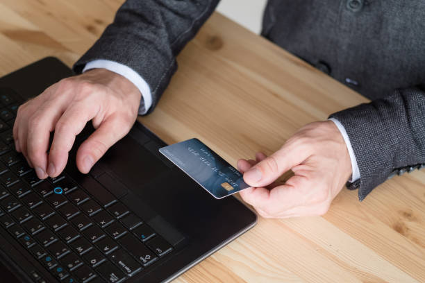 istock online payment man typing data credit card laptop 1057826350