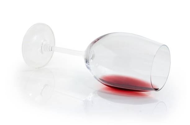 istock Glass lying on its side with small amount of wine 1057830374