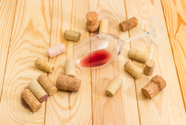 istock Glass with wine lying on its side among of corks 1057830506