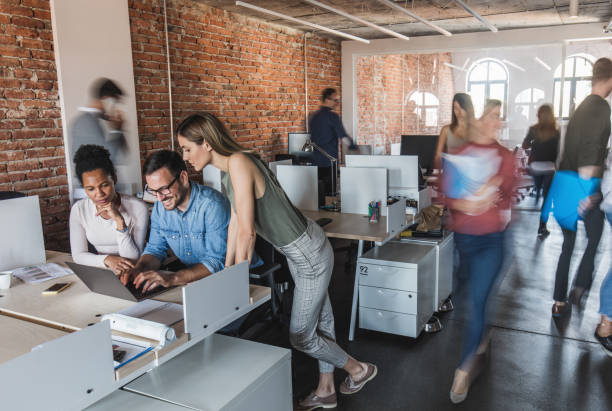 istock Working on laptop at busy corporate office! 1057832166