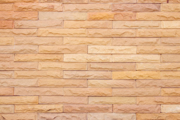 istock Seamless Natural pattern of decorative brick sandstone wall surface with concrete of modern style design decorative uneven have cracked realmasonry wall of multicolored stones or blocks with cement. 1057833086