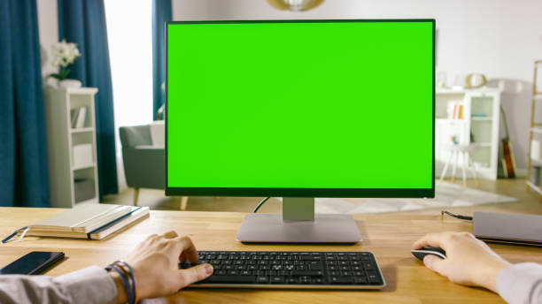 istock First Person View of Professional Freelancer Working on Green Mockup Screen Personal Computer From Home. Close-up POV Shot. In the Background Cozy Living Room. 1057833332