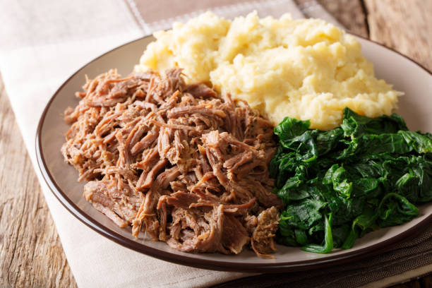 istock Botswana cuisine: seswaa beef stew with pap porridge and spinach close-up on a plate. horizontal 1057836020