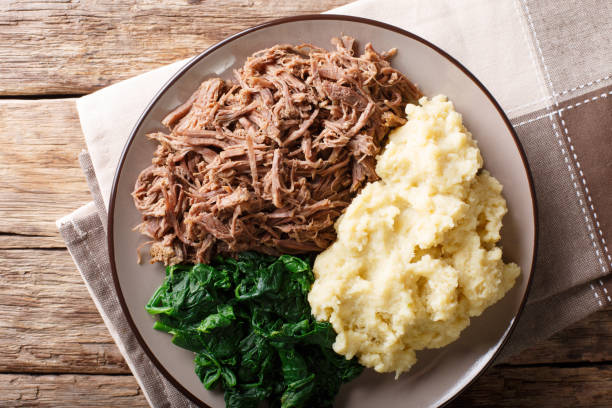 istock Botswana food - Seswaa stewed beef with Sadza from corn flour and spinach, close-up. horizontal top view 1057836046